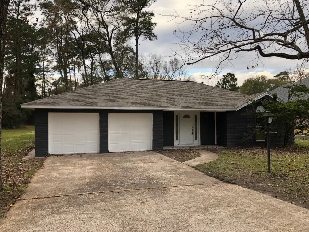 24803 Hickory Hill Road Spring, TX 77380 - Photo 1 of 13 a front view of a house with a yard and garage