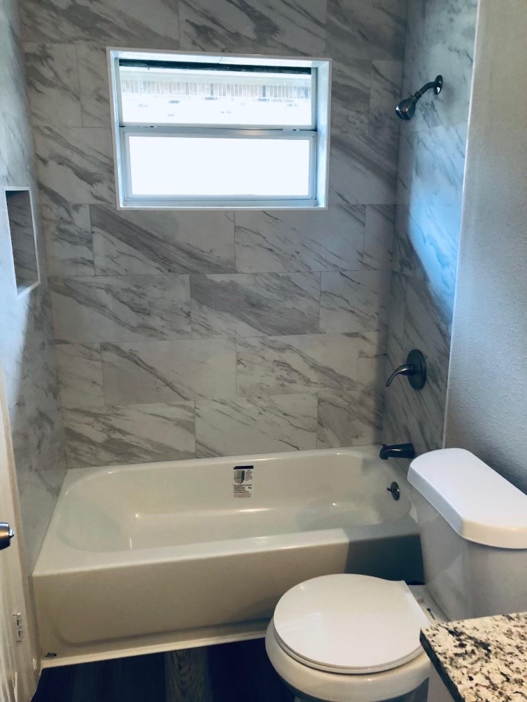 24803 Hickory Hill Road Spring, TX 77380 - Photo 13 of 13 a bathroom with a toilet and a bath tub