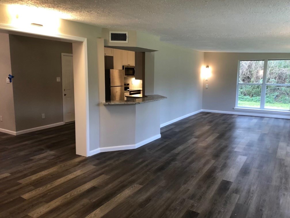 24803 Hickory Hill Road Spring, TX 77380 - Photo 4 of 13 an empty room with wooden floor and windows