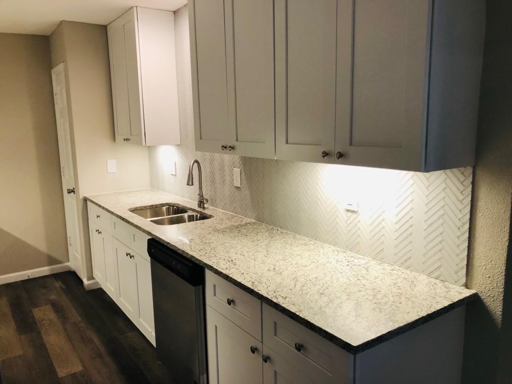 24803 Hickory Hill Road Spring, TX 77380 - Photo 8 of 13 a kitchen with granite countertop cabinets and white appliances