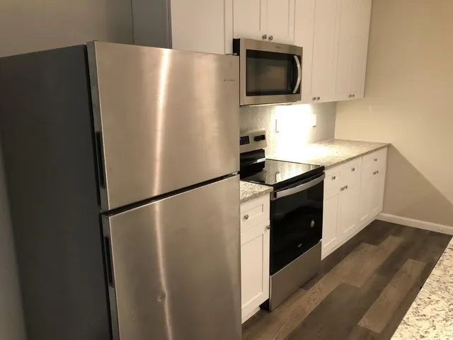 a white refrigerator freezer sitting in a kitchen
