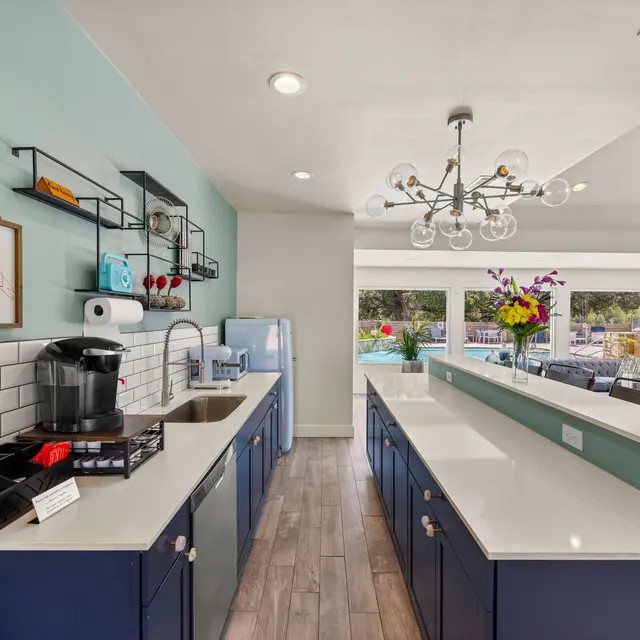 13005 Heinemann Drive, Unit 131312 Austin, TX 78727 - Photo 6 of 17 a kitchen with lots of counter top space a sink and wooden floor