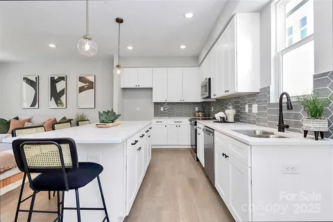 a kitchen with a sink stove and cabinets