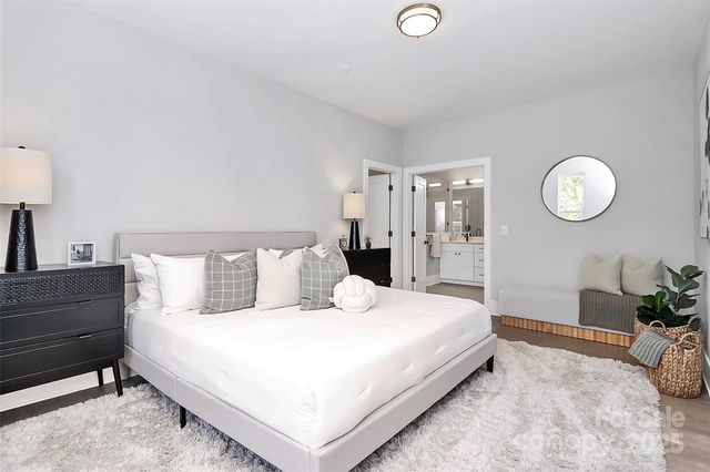 a bedroom with a bed and a potted plant