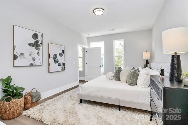 a bedroom with a bed and a couch