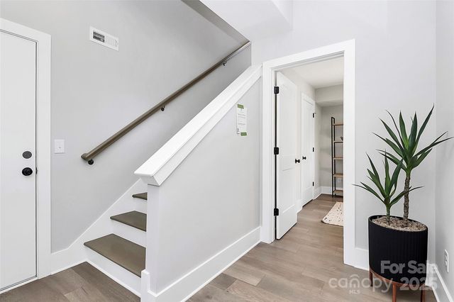 a view of entryway with stairs and wooden floor