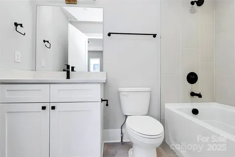 a bathroom with a sink toilet a mirror and shower