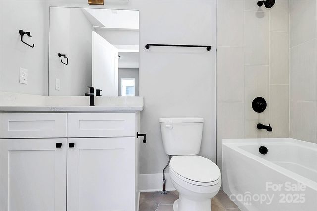 a bathroom with a sink toilet a mirror and shower