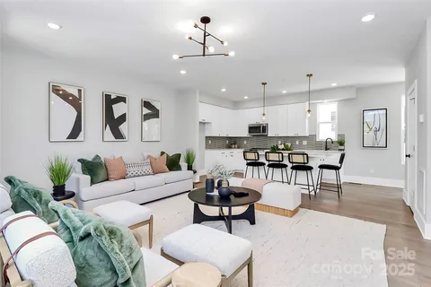 a living room with furniture kitchen view and a dining table