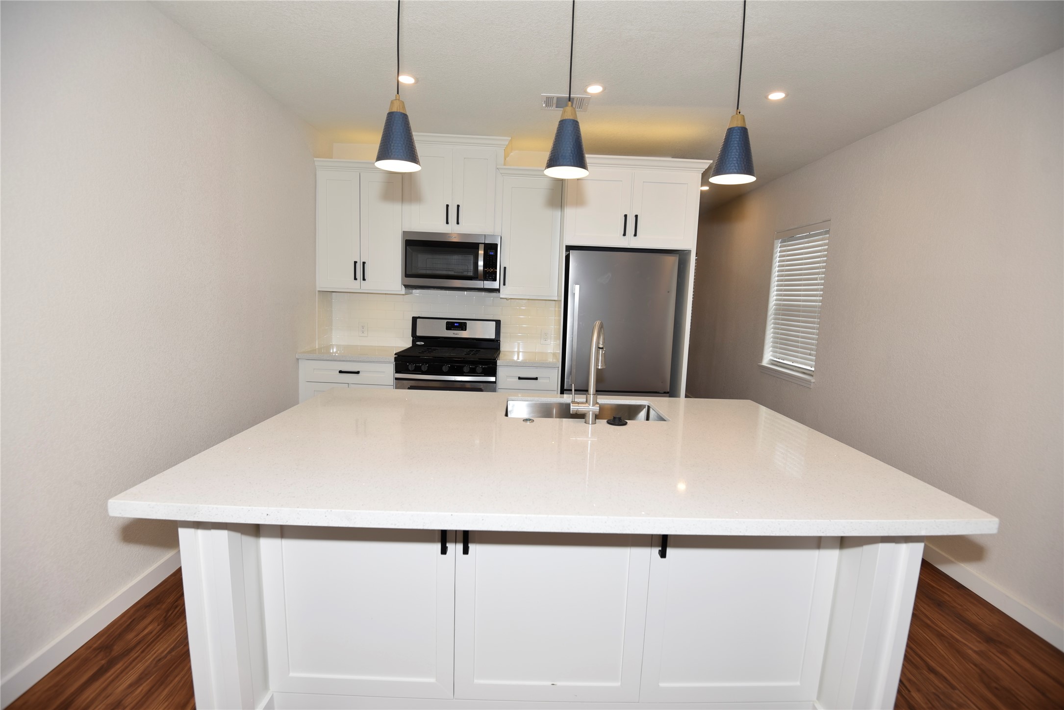 4322 Allen Street Houston, TX 77007 - Photo 1 of 17 a kitchen with stainless steel appliances a refrigerator sink and wooden floor