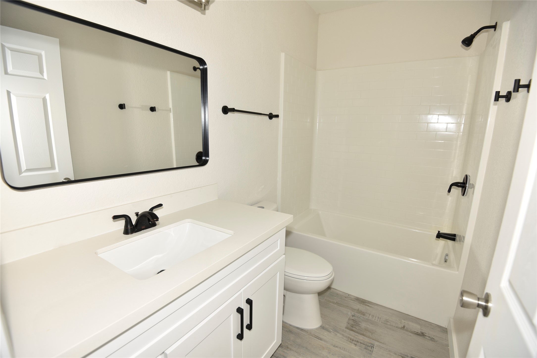 4322 Allen Street Houston, TX 77007 - Photo 12 of 17 a bathroom with a sink a toilet and shower