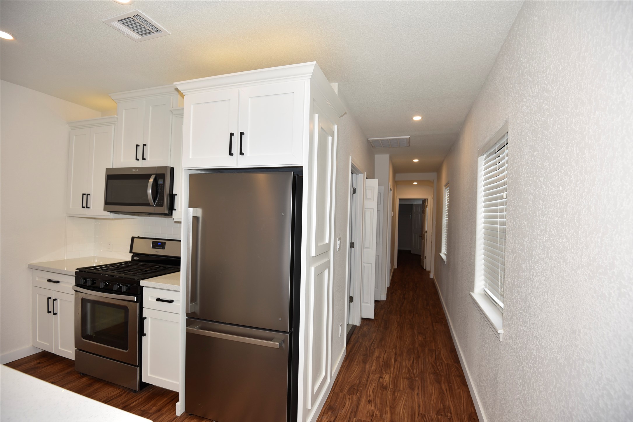 4322 Allen Street Houston, TX 77007 - Photo 16 of 17 a kitchen with stainless steel appliances a refrigerator sink and microwave