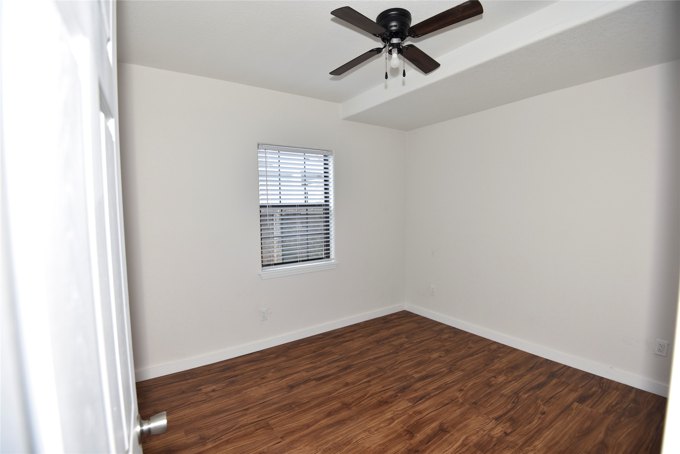 4322 Allen Street Houston, TX 77007 - Photo 9 of 17 an empty room with wooden floor fan and windows