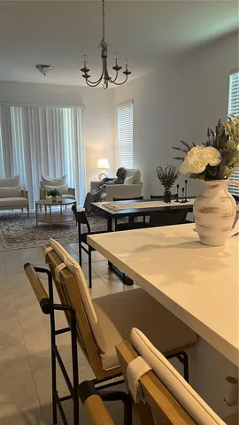 a room with a table chairs and wooden floor