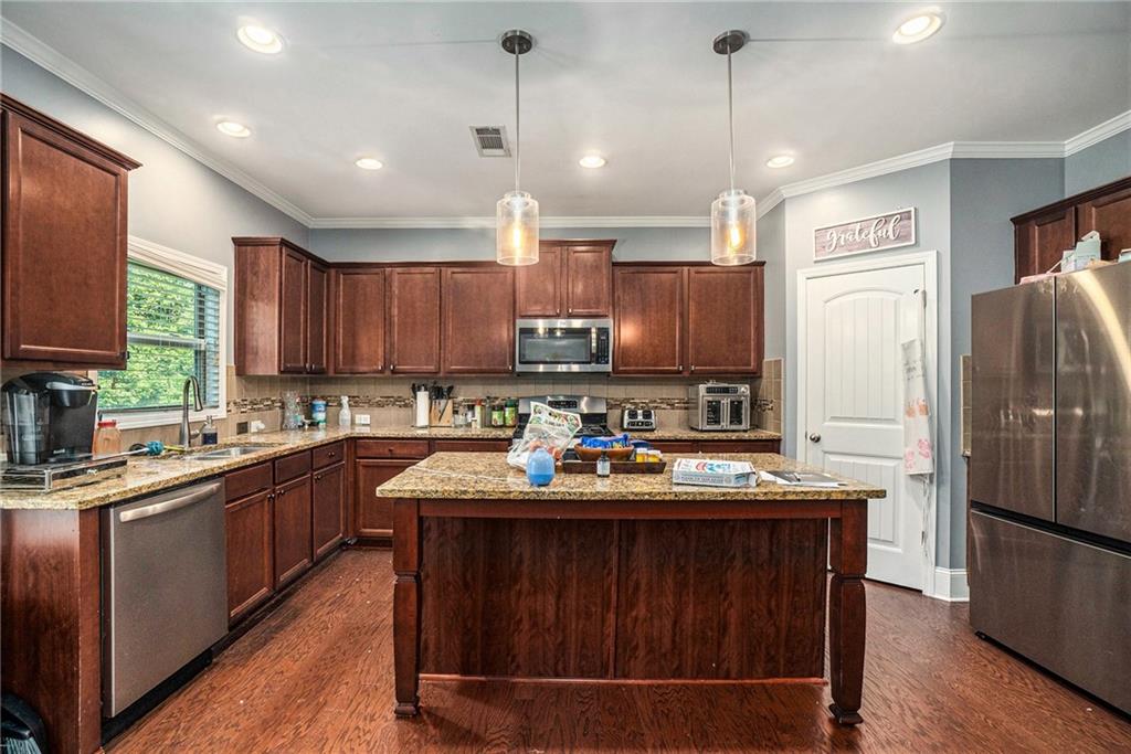 566 Olympic Way Acworth, GA 30102 - Photo 12 of 29 a kitchen with a sink refrigerator and microwave