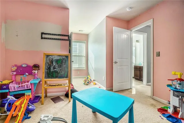 a bathroom with a sink a toilet and a large mirror