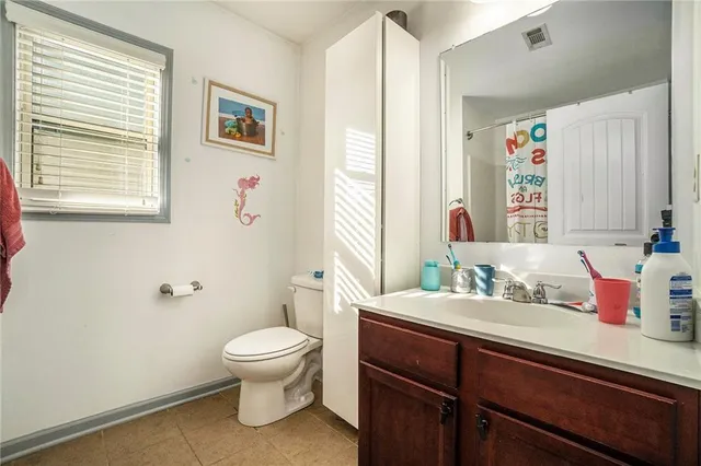 a spacious bedroom with a bed and a desk