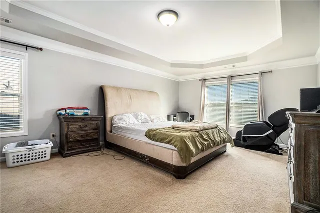 a bedroom with a bed and a couch