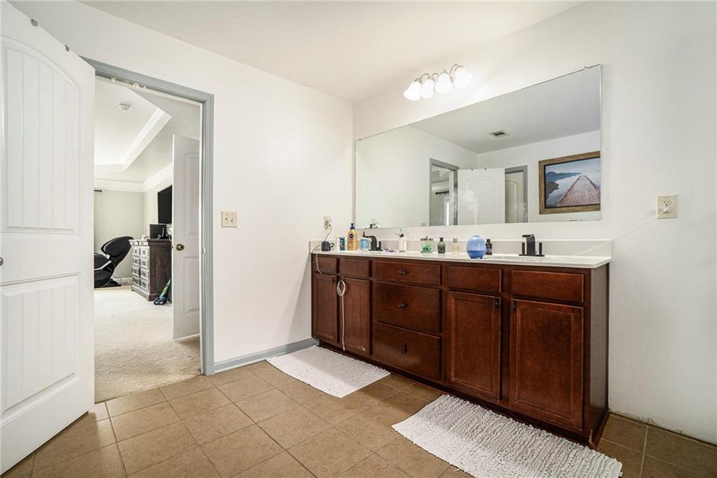 566 Olympic Way Acworth, GA 30102 - Photo 20 of 29 a bathroom with a sink vanity and mirror