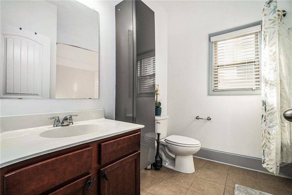 566 Olympic Way Acworth, GA 30102 - Photo 25 of 29 a bathroom with a sink toilet and a mirror