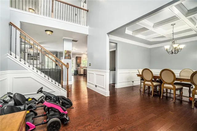 a dining room with furniture entryway and wooden floor