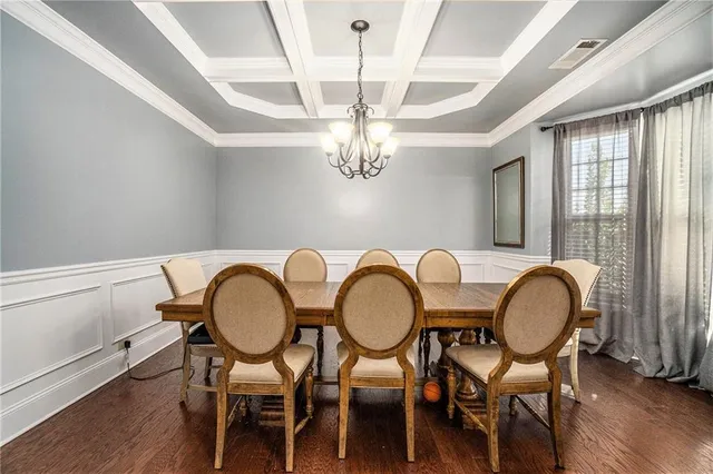 a dining room with furniture and a chandelier