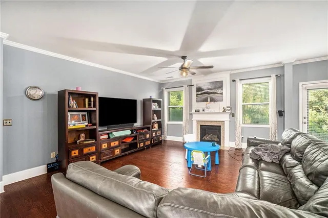 a living room with furniture a fireplace and a flat screen tv