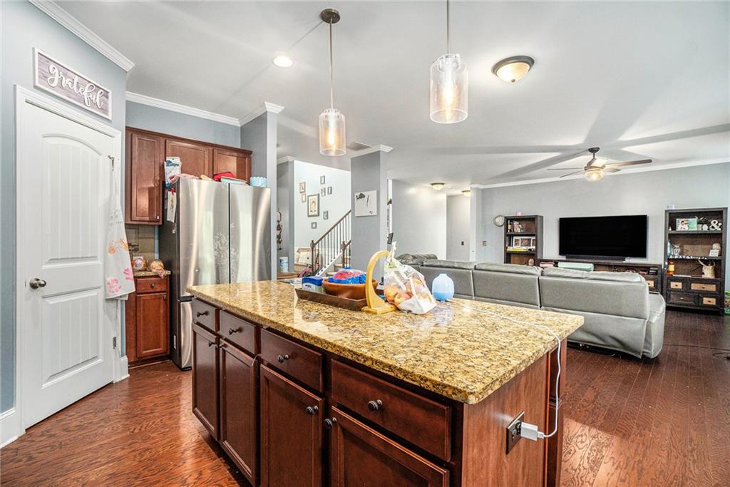 566 Olympic Way Acworth, GA 30102 - Photo 10 of 29 a kitchen with stainless steel appliances granite countertop a sink refrigerator and wooden floor