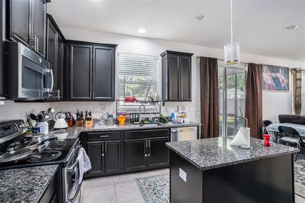 a kitchen with a stove a sink and a refrigerator