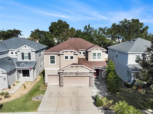 an aerial view of a house with a yard