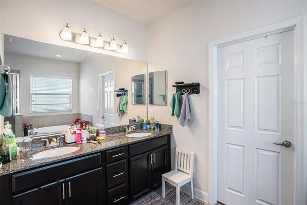a bathroom with a double vanity sink and mirror