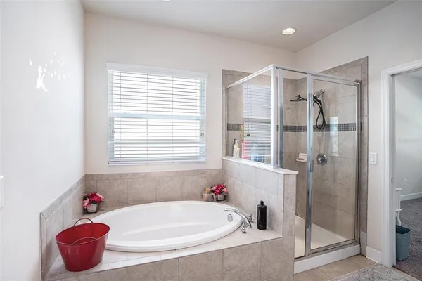 a bathroom with a tub and shower