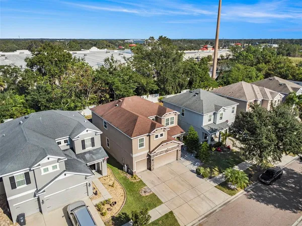 an aerial view of a house with a yard
