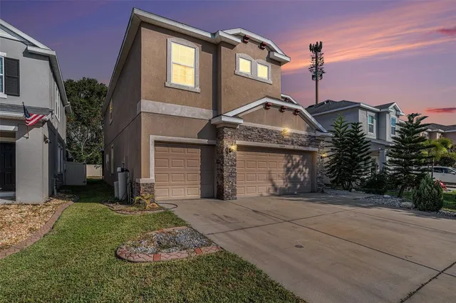 a front view of a house with a yard and garage
