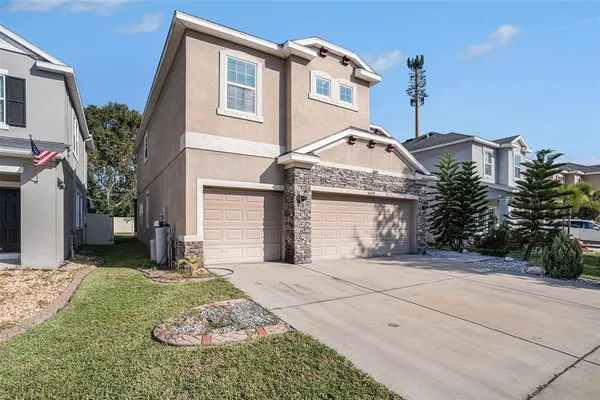a front view of a house with a yard and garage