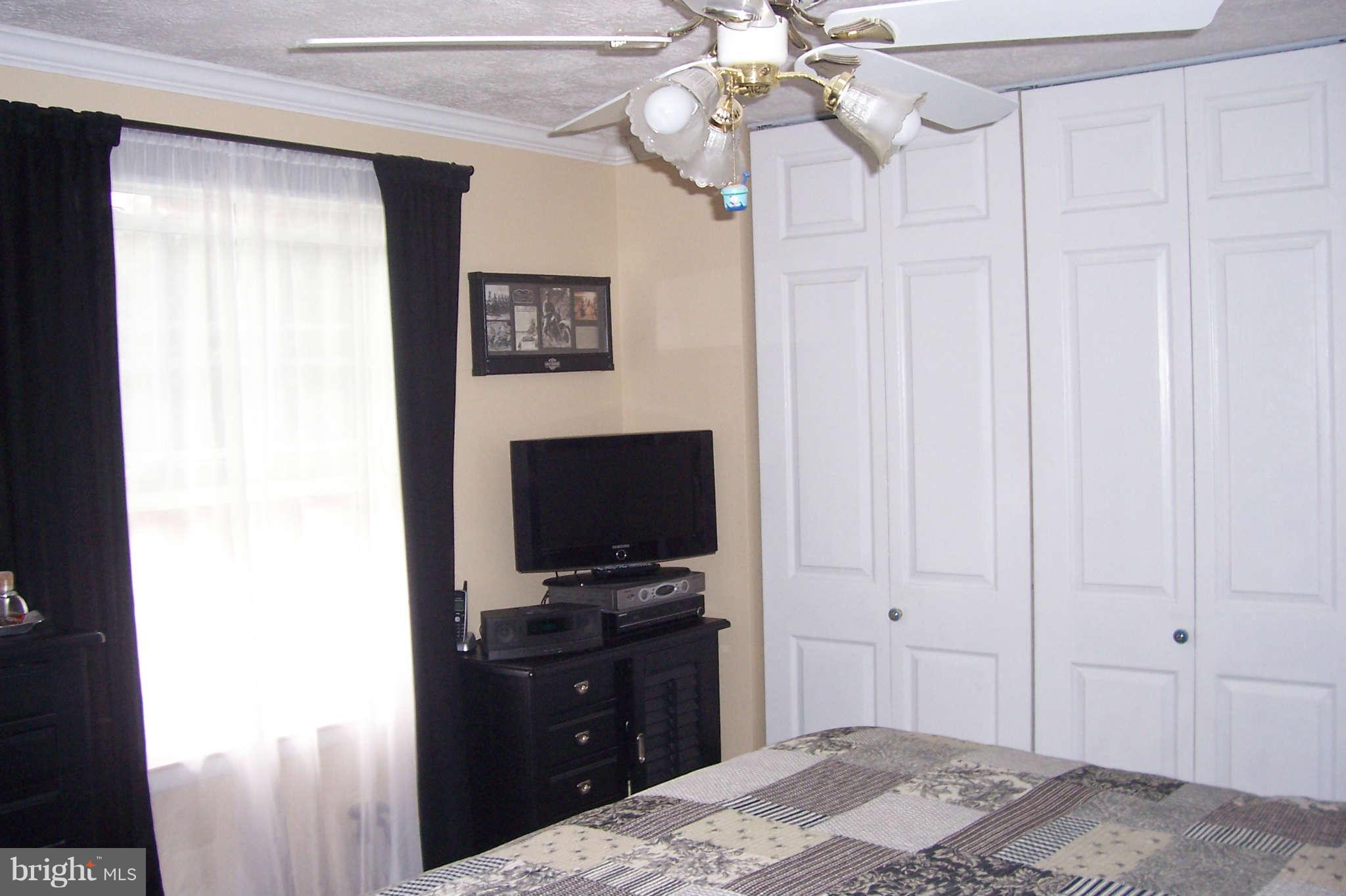 32 Yew Road Baltimore, MD 21221 - Photo 13 of 30 a bedroom with a bed and a flat tv screen on dresser