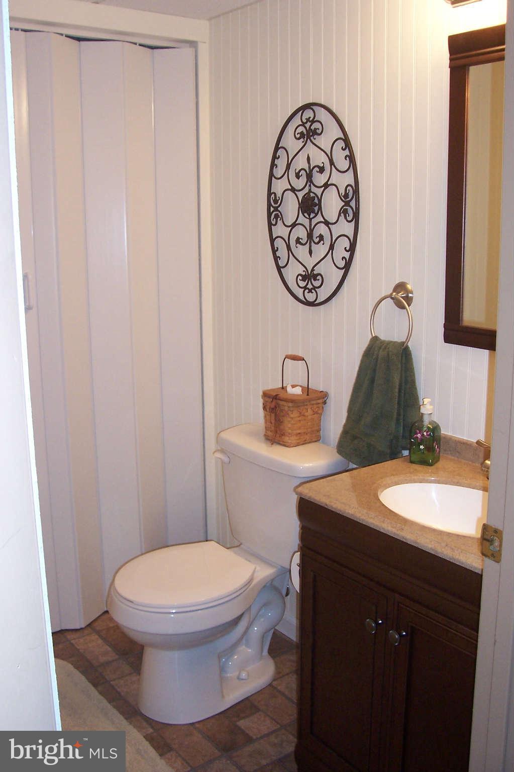 32 Yew Road Baltimore, MD 21221 - Photo 19 of 30 a bathroom with a toilet a sink and a mirror