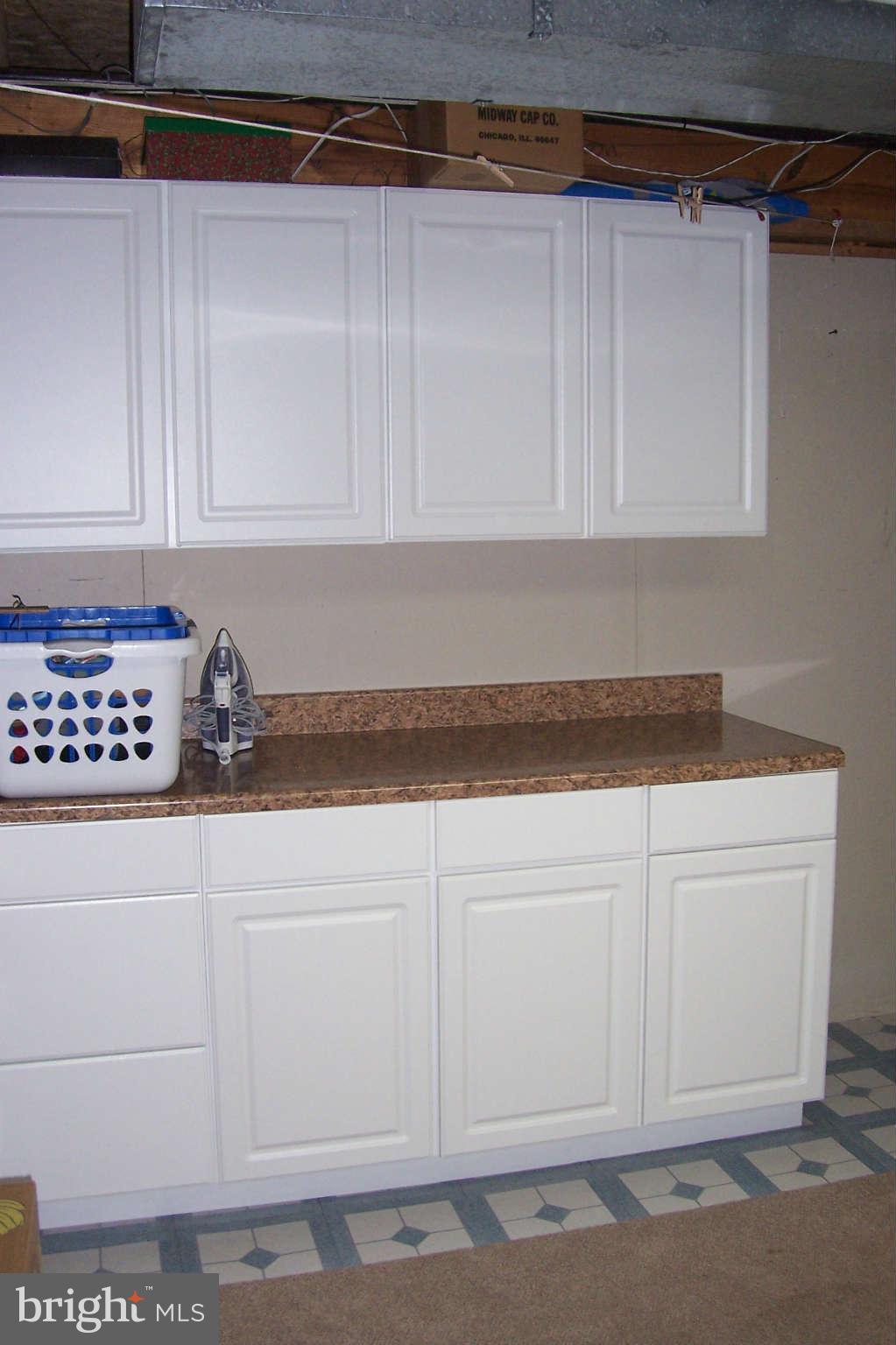 32 Yew Road Baltimore, MD 21221 - Photo 20 of 30 a kitchen with white cabinets and sink