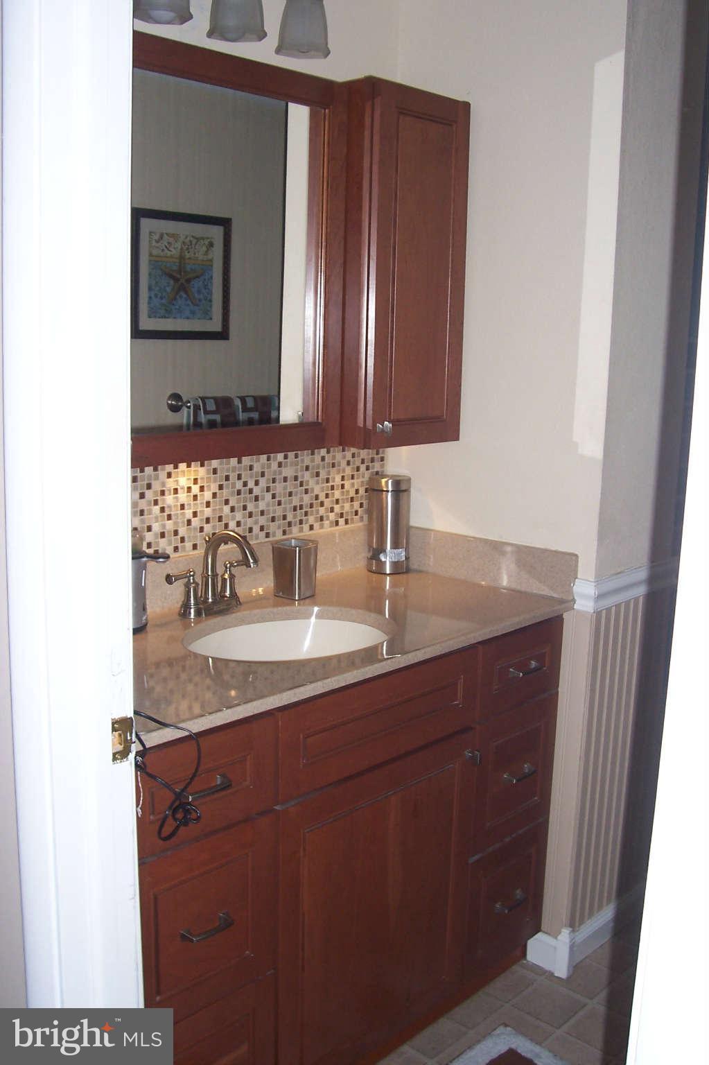 32 Yew Road Baltimore, MD 21221 - Photo 10 of 30 a bathroom with a granite countertop sink and a mirror