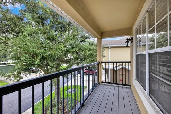a view of balcony with wooden floor