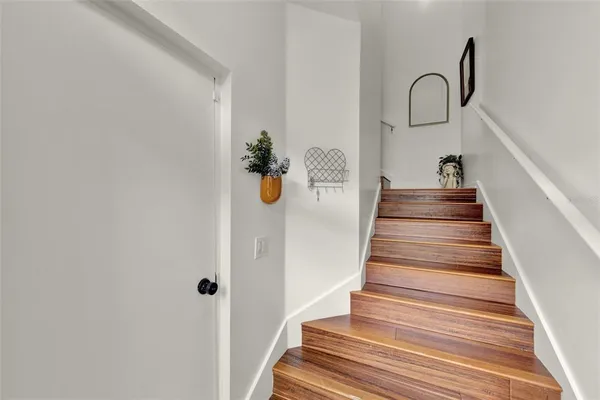 a view of entryway and hall with wooden floor