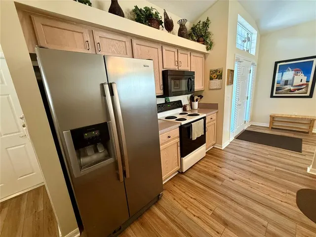 a kitchen with stainless steel appliances a refrigerator stove and microwave