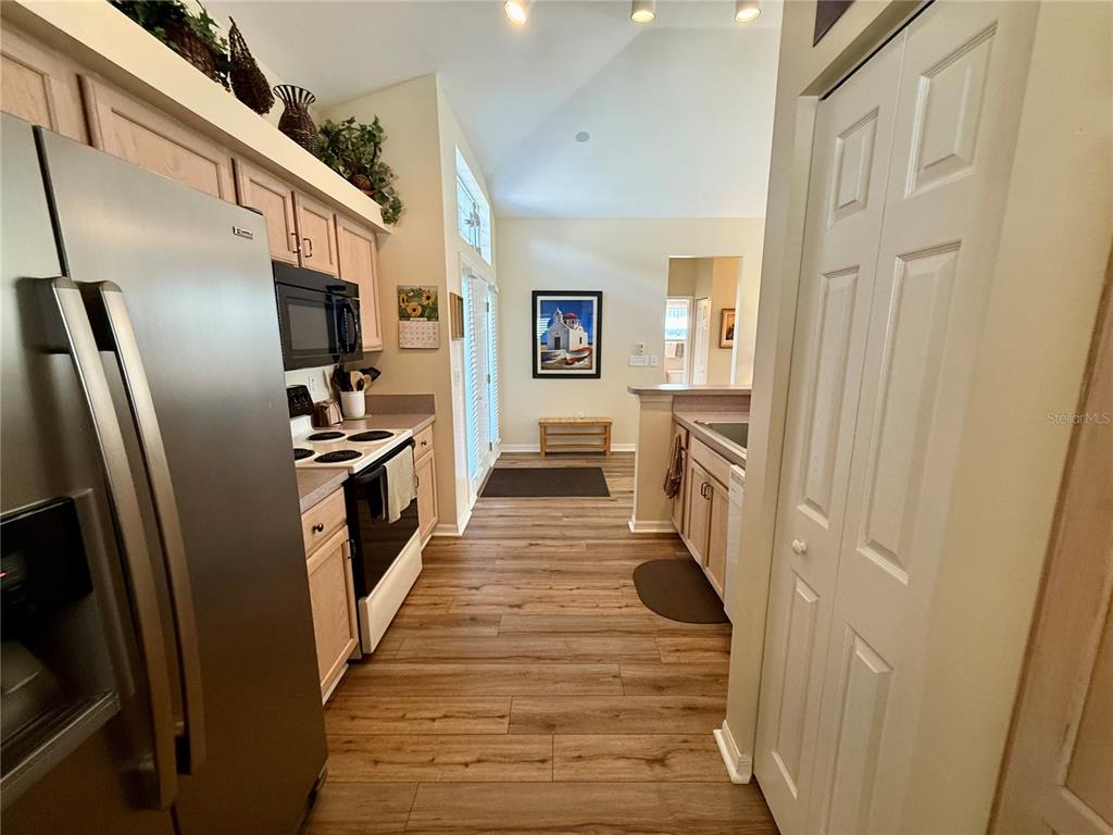 11122 Southwest 73rd Court Ocala, FL 34476 - Photo 16 of 36 a view of a kitchen from the hallway
