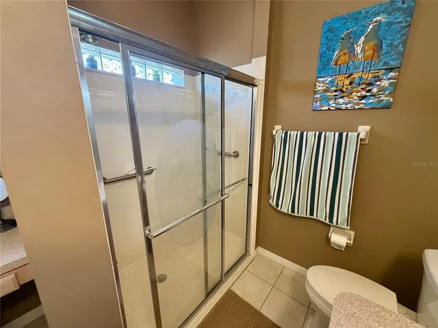 a bathroom with a window and a shower