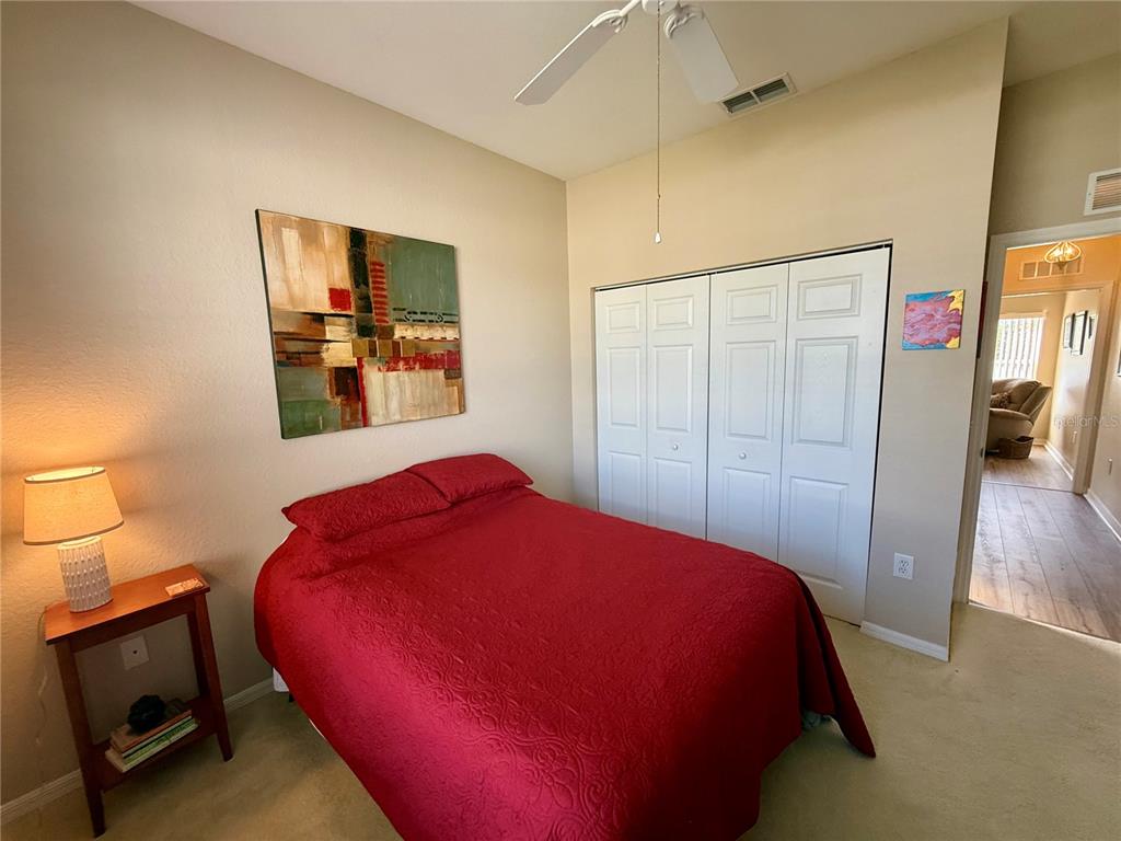 11122 Southwest 73rd Court Ocala, FL 34476 - Photo 27 of 36 a bedroom with a bed and a painting on the wall