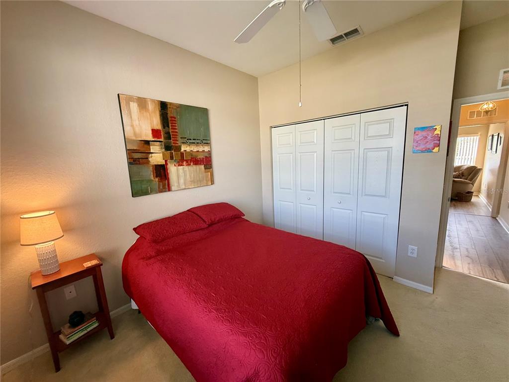 11122 Southwest 73rd Court Ocala, FL 34476 - Photo 28 of 36 a bedroom with a bed and wooden floor