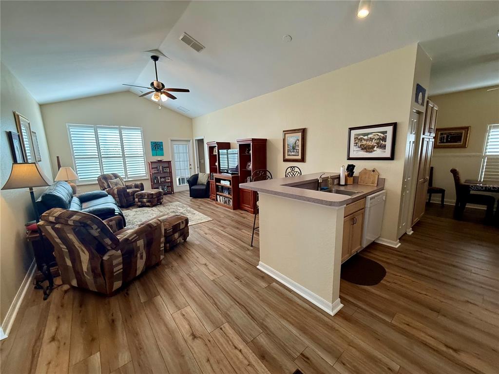 11122 Southwest 73rd Court Ocala, FL 34476 - Photo 5 of 36 a living room with furniture and a wooden floor