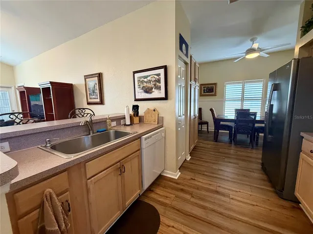 a kitchen with sink cabinets and wooden floor