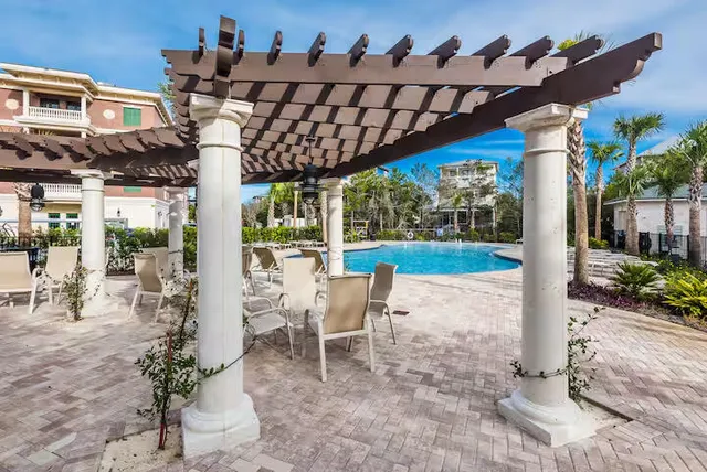a view of a patio with table and chairs potted plants