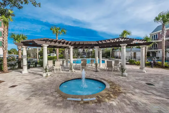 a view of a house with backyard porch and sitting area